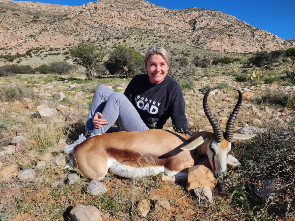 Female Hunter next to springbok Female Hunter next to springbok