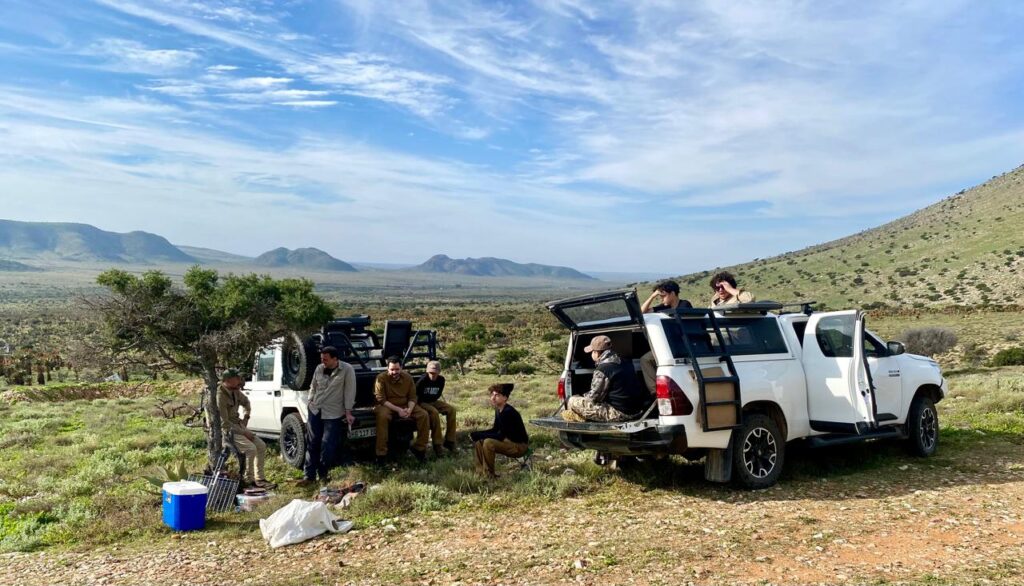 Hunters Relaxing by a bakkie in the bush Hunters Relaxing by a bakkie in the bush